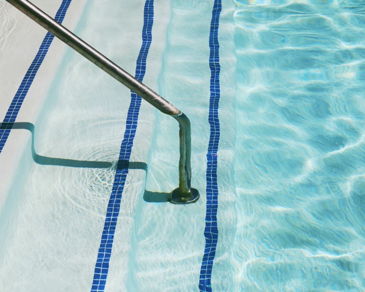 a swimming pool with a blue strip in the water