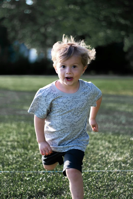 a small child in a field running towards the camera