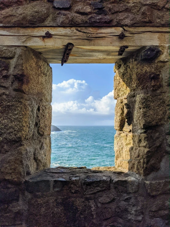 a small window in a rock covered wall