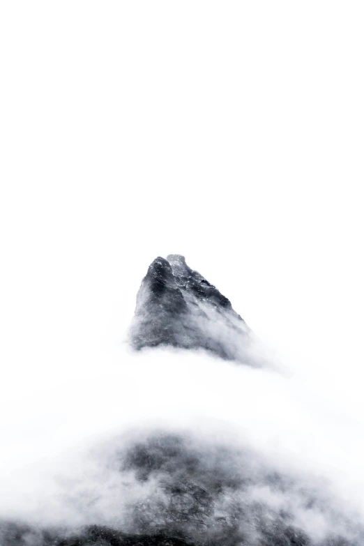 a big tall mountain surrounded by fog in the sky