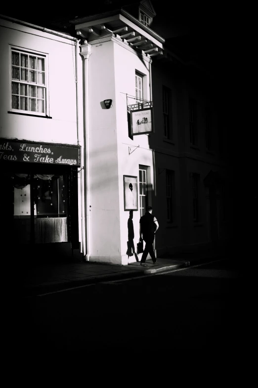 two people are outside of a small building