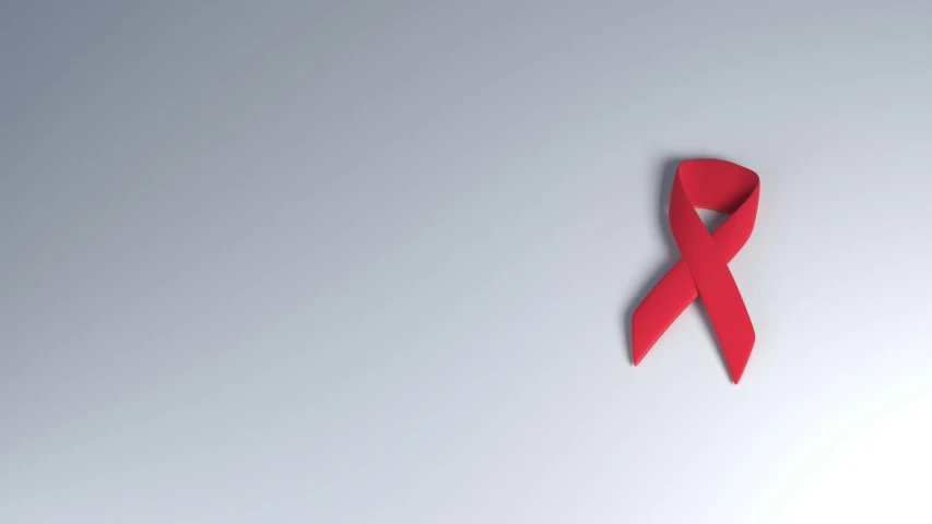 a red ribbon pinned to a gray wall