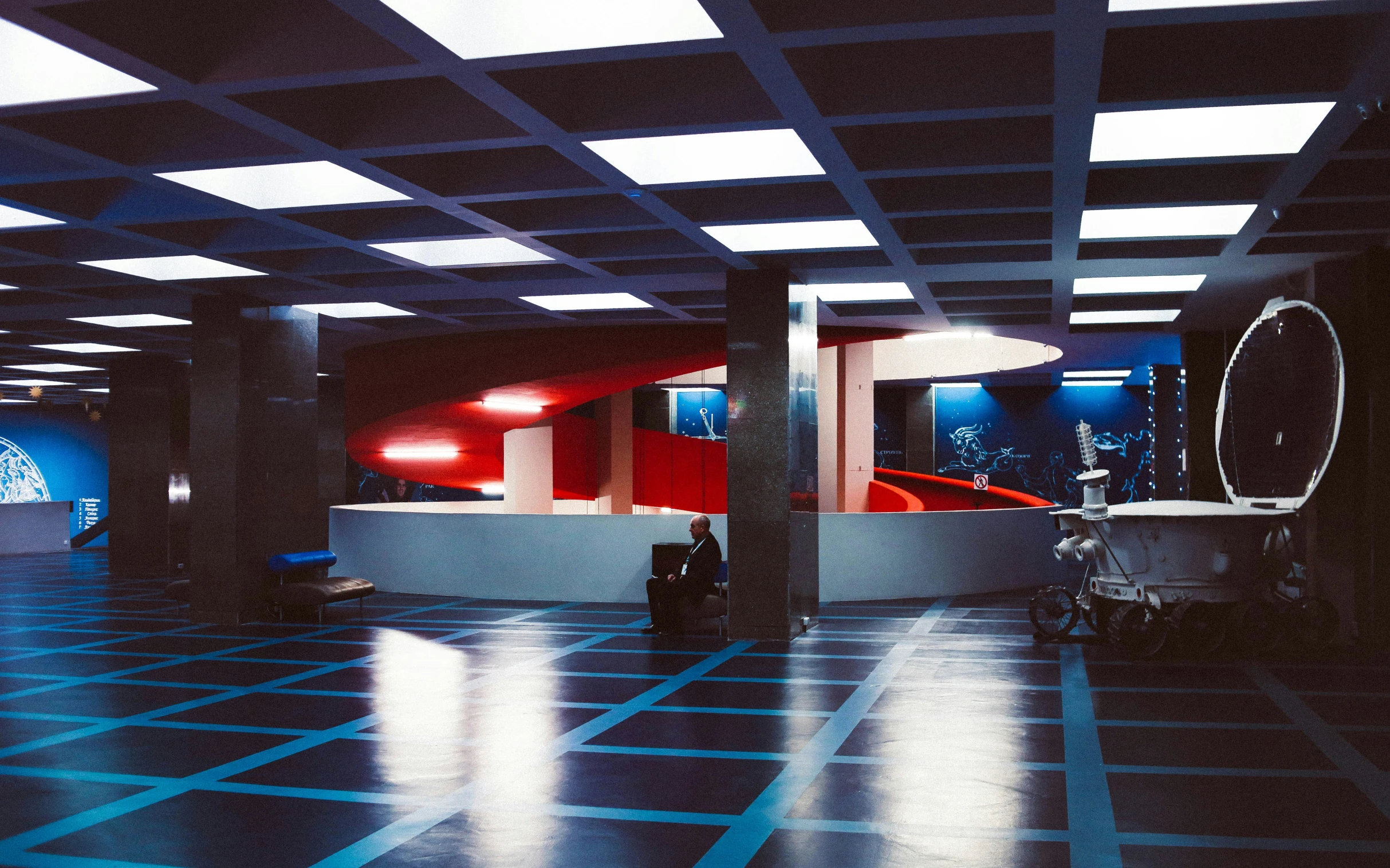 the inside of an empty building with blue floor tiles