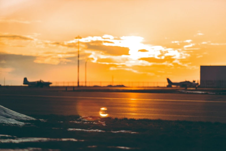 the sunsets on an airport, just after it was lit by airplanes