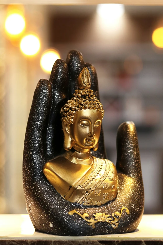 the buddha statue is gold in color