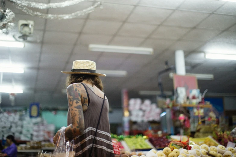 a man with tattooed arm wearing a hat