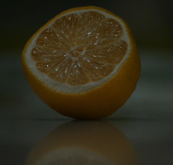 an orange cut in half sitting on top of a table