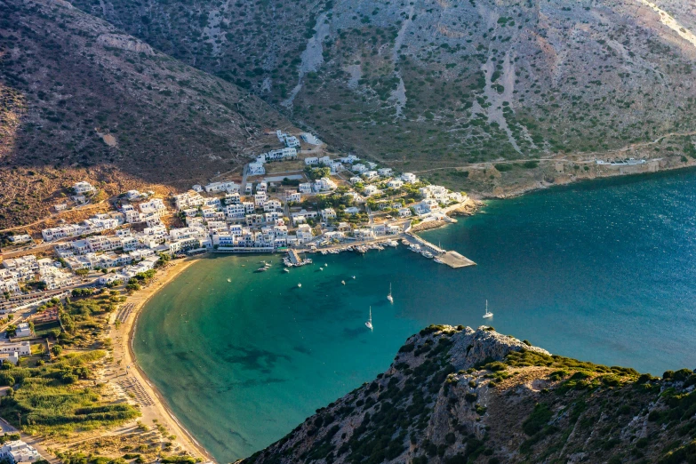 a bay with boats in the water and mountains in the background