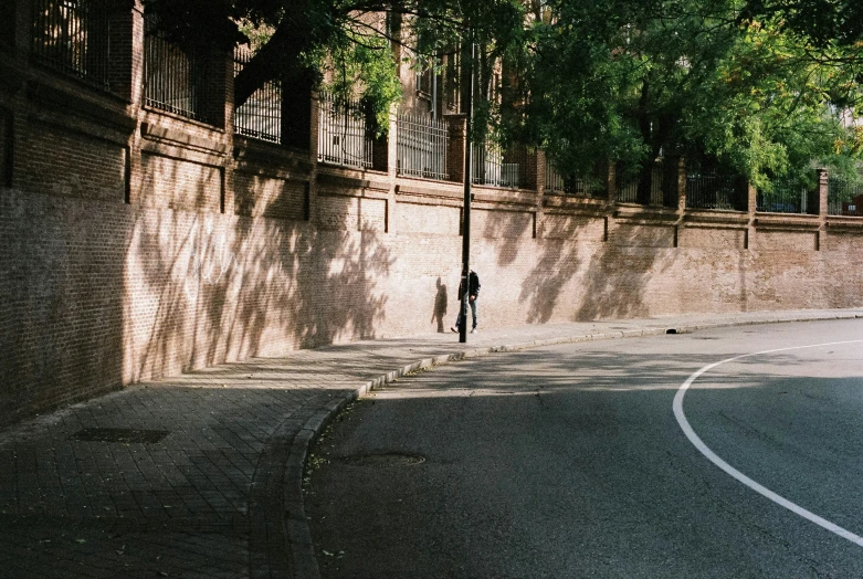 two men standing by a street corner at dusk