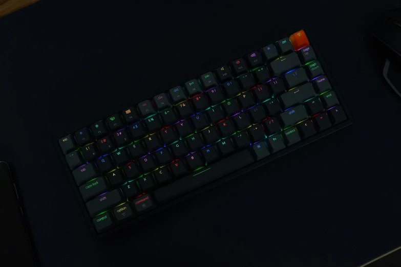 a black and red glowing keyboard next to a mouse