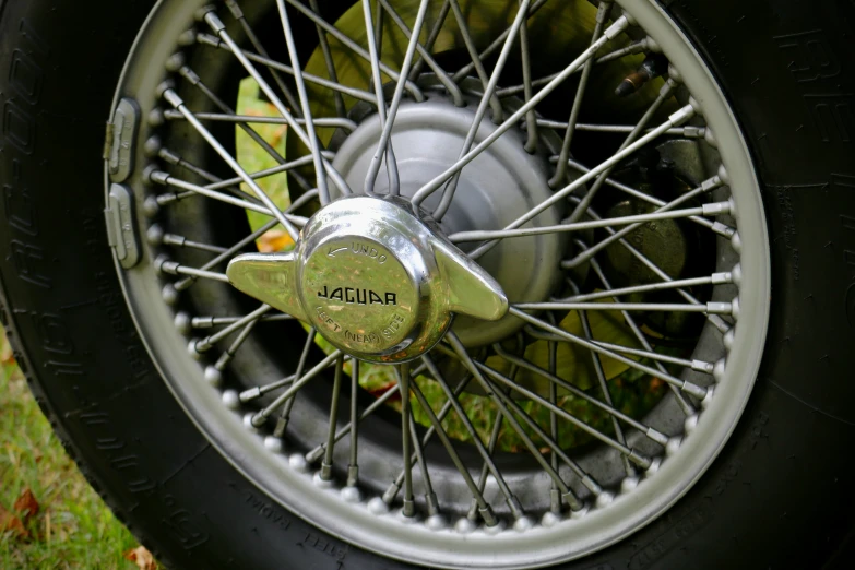 the wheel of an old car is on display