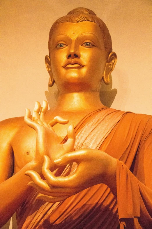 there is a golden buddha statue holding soing