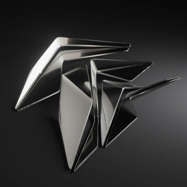 three metal abstract objects, one of which has triangular shapes and two are slightly pointed