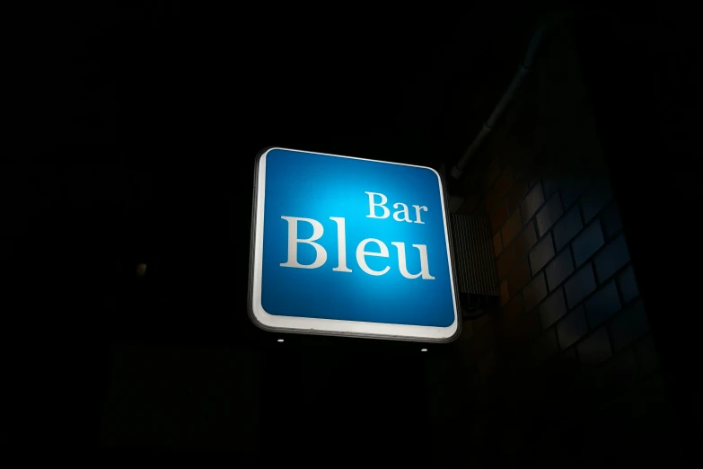 there is a blue bar sign at night