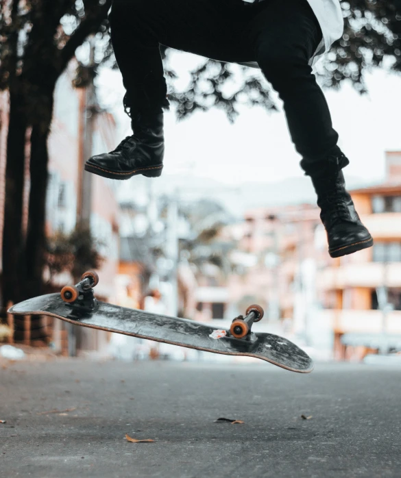 a person jumping in the air over a skateboard