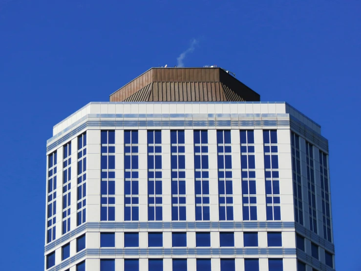 an airplane flying near a skyscr building in the daytime