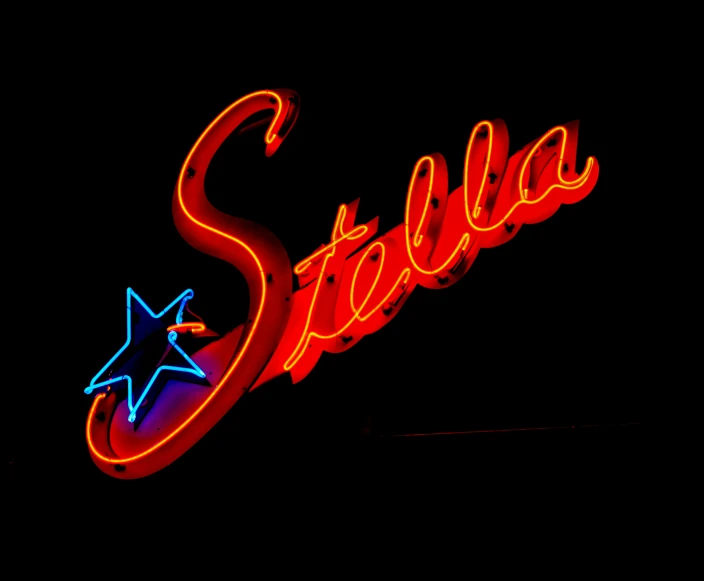 red neon sign saying stella with a star at the bottom