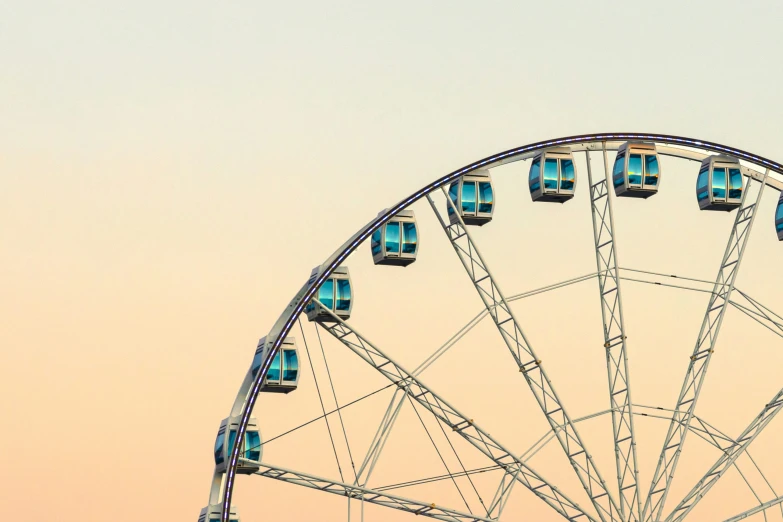 a ferris wheel with four lights is shown at dusk