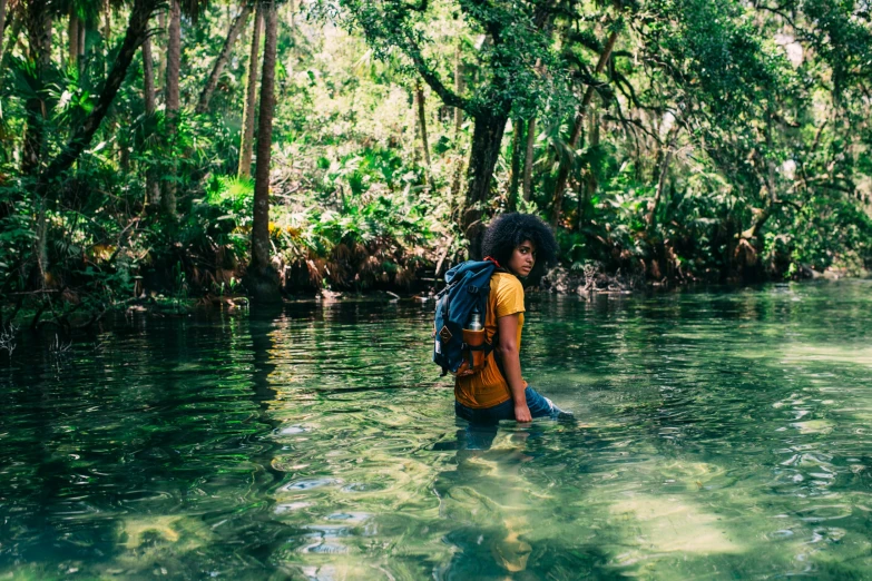 a boy is standing in the water