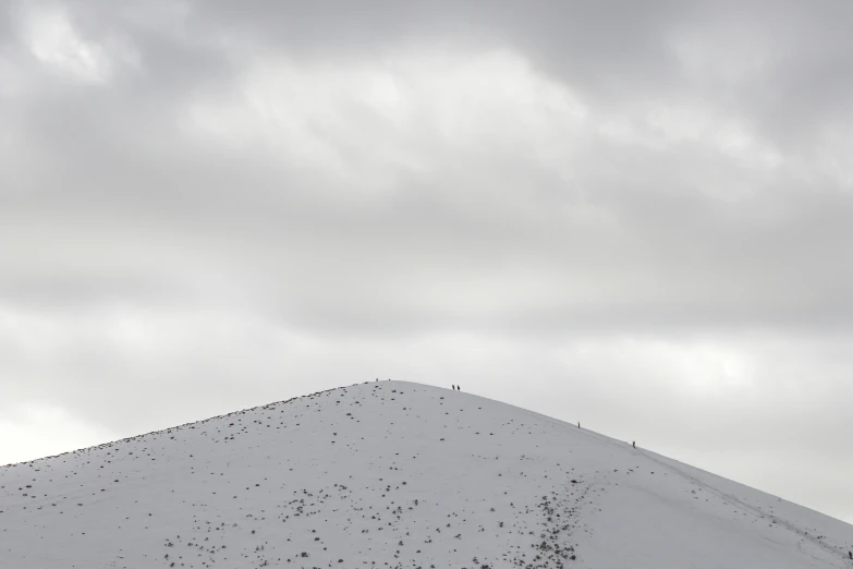 some people on a snow hill with a ski