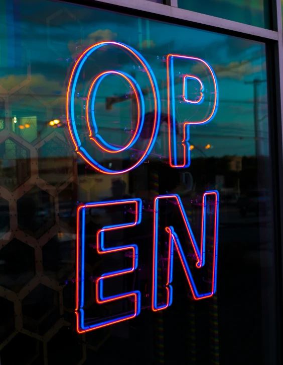 a lighted sign on the side of a store