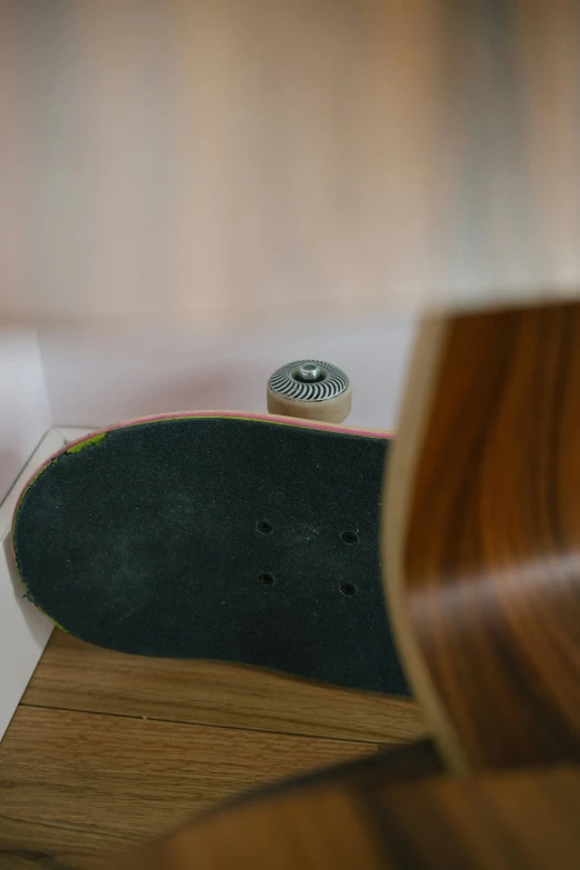 a skateboard rests upon a plywood surface