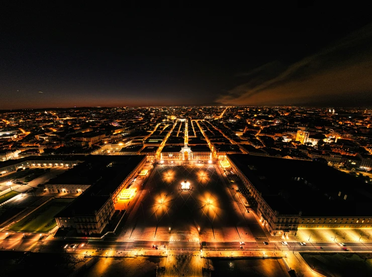 an aerial view at night, lights and structures in darkness