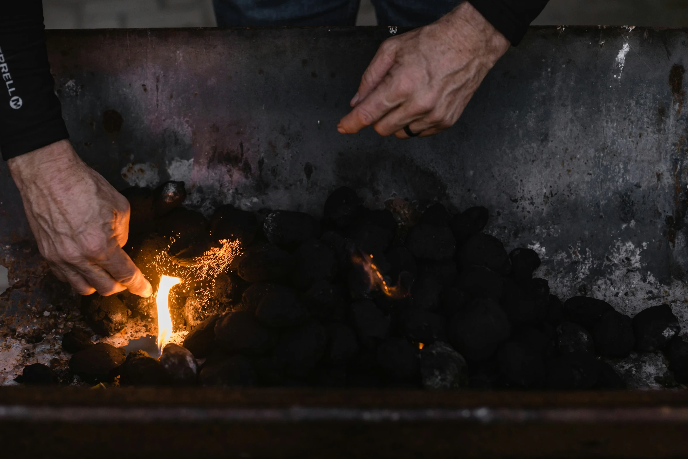 two hands, one reaching for soing in a stove