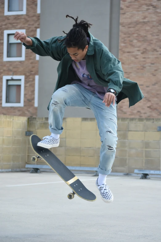 the man is jumping in the air on his skateboard