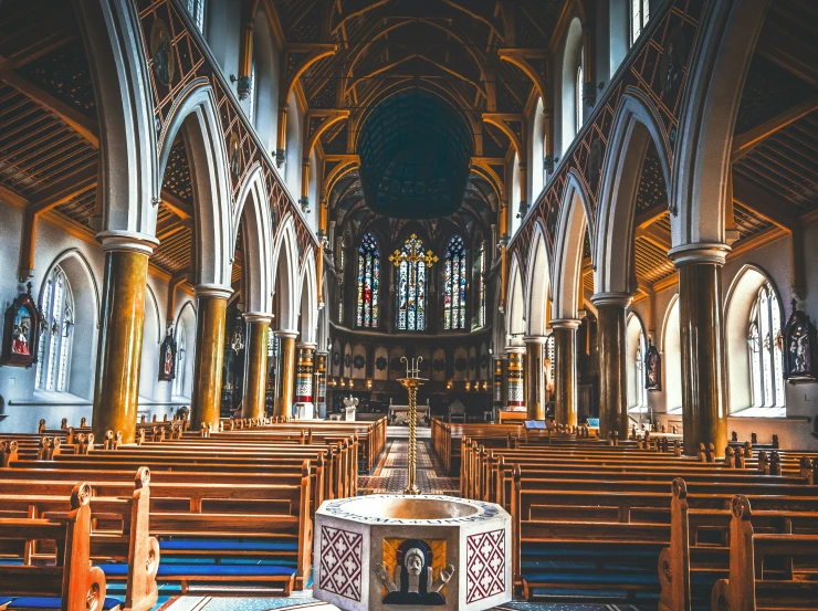 an empty church with pews and stained glass windows