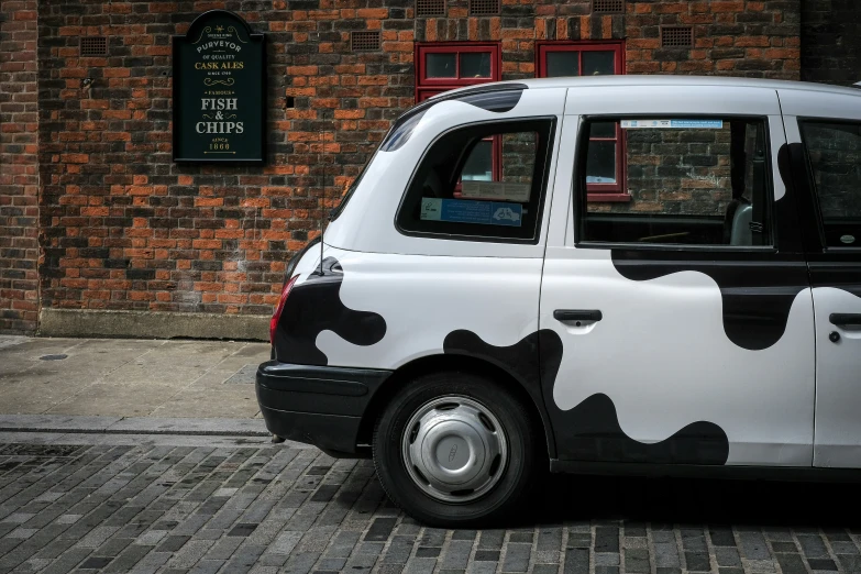 a picture of a taxi cab in front of a brick building