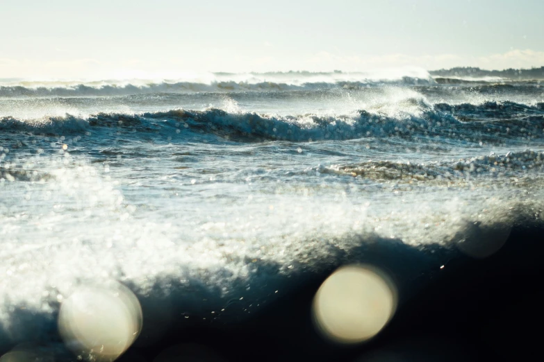 the sun reflects off of the rough ocean water