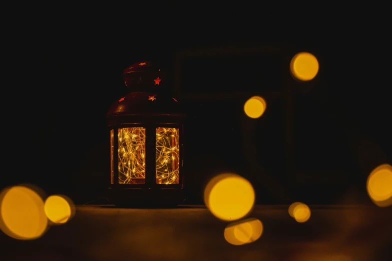 an old fashioned lit lamp in the dark