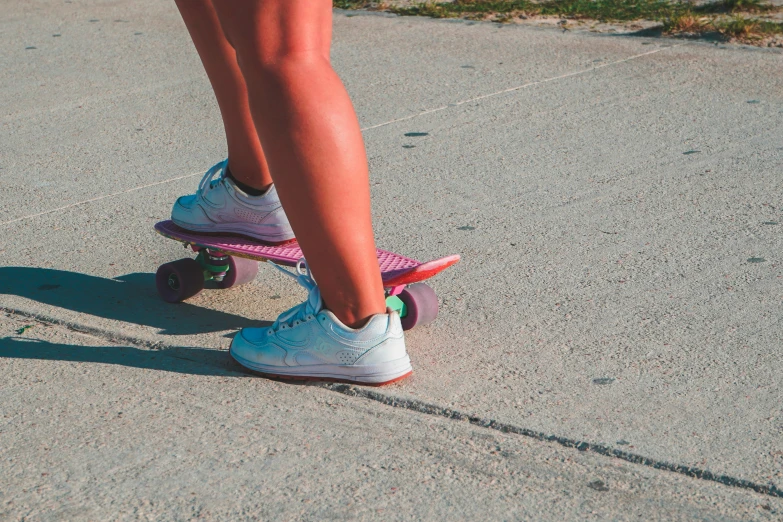 the legs of a person riding on a skateboard