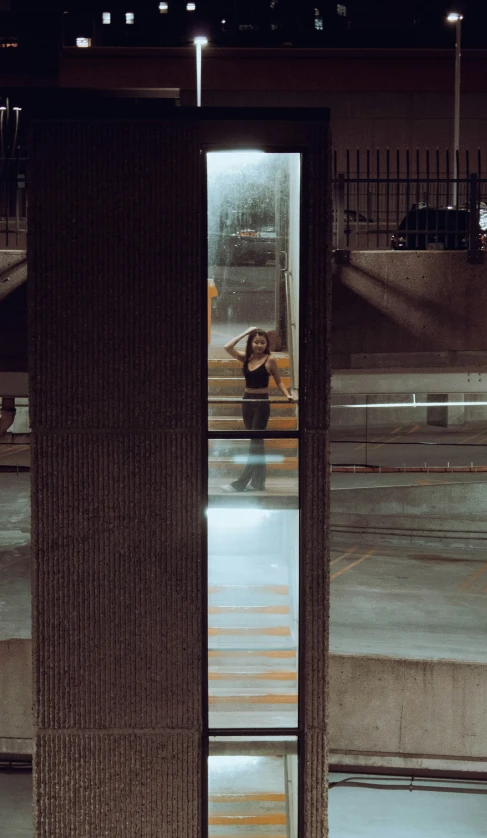 person looking out an open door at the city at night