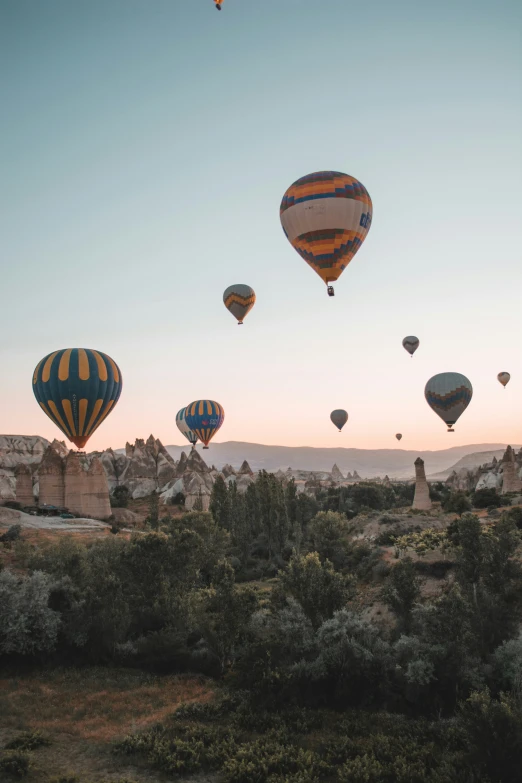 the sky has many  air balloons flying overhead