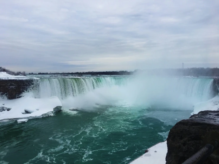 an image of a large waterfall in winter time