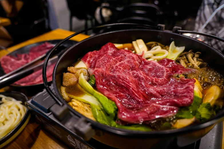 a close up of meat in a pan on a stove