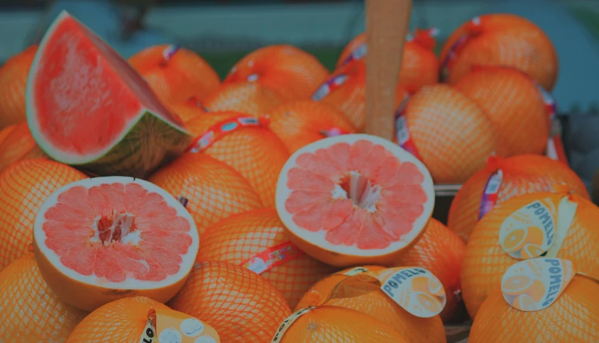 several slices of orange fruit, one cut in half and the other stacked in front