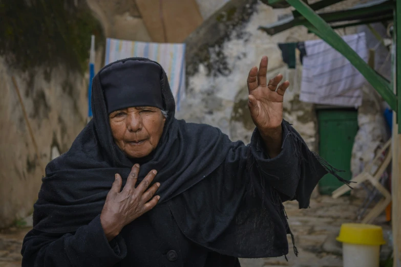 woman with a black hijab standing outside