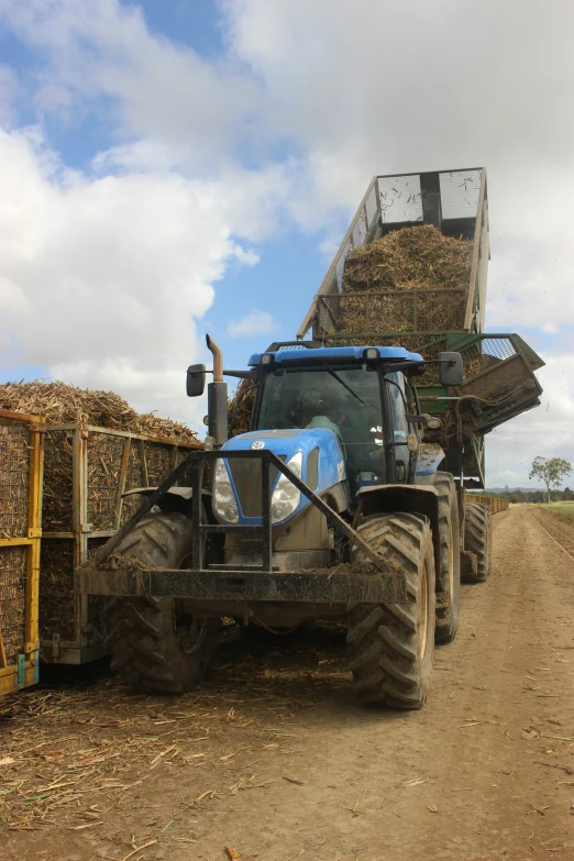 a tractor is pulling bales full of hay