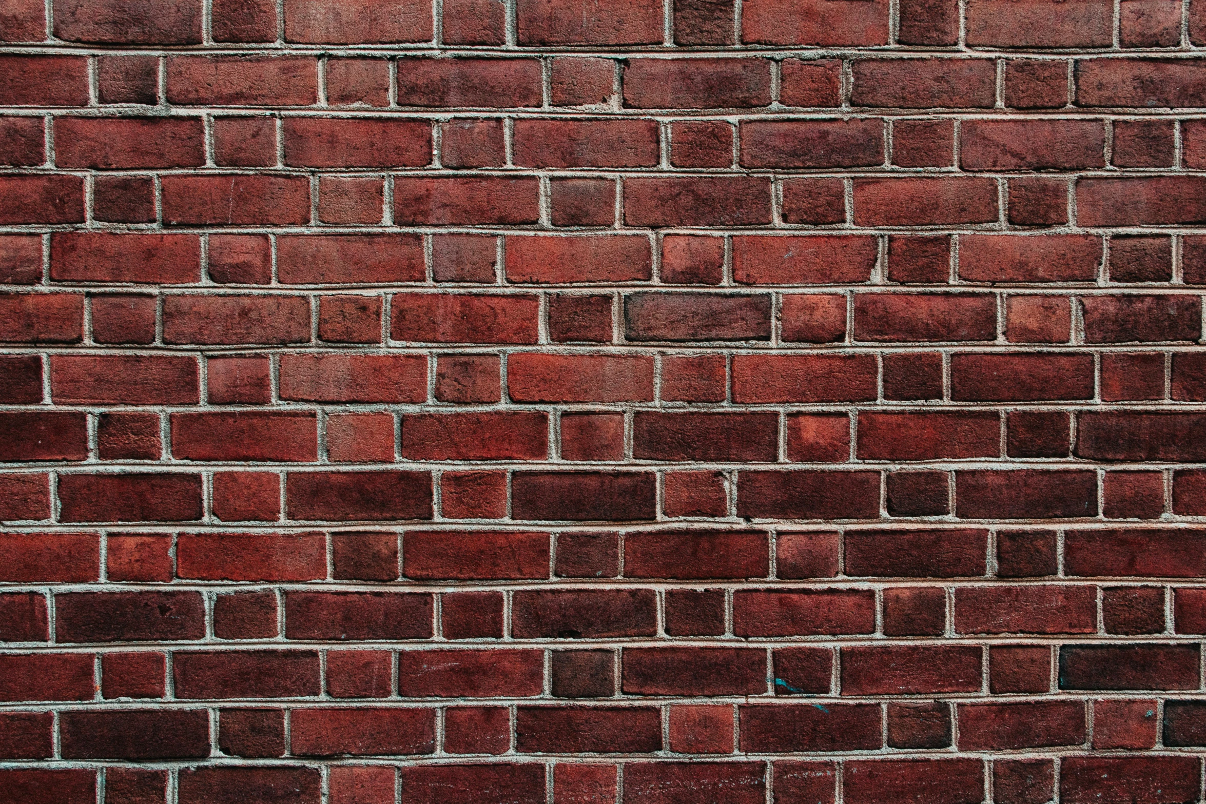 a closeup image of a brick wall and a street light