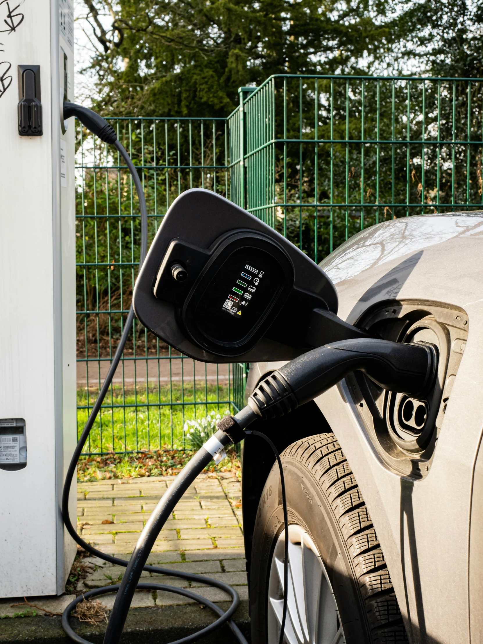 a car plugged in to an electric vehicle charging station