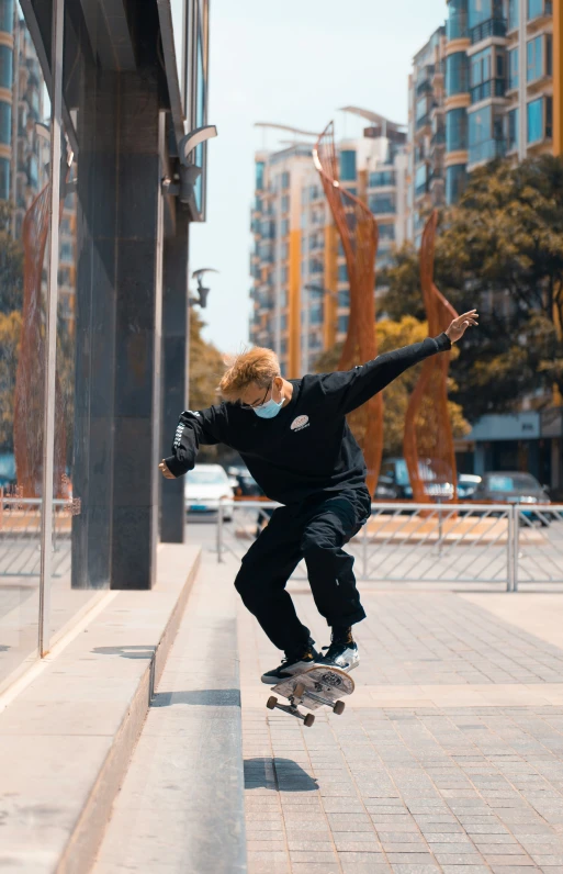 a man in black jacket doing a trick on skateboard