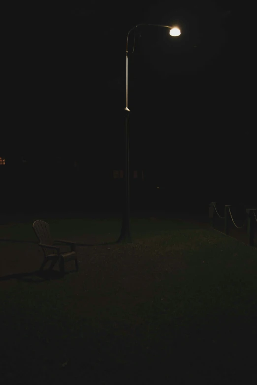 a dark po of a park bench at night