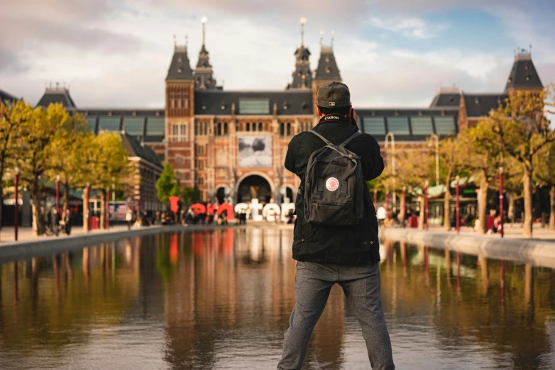 a person with their arms outstretched near the water