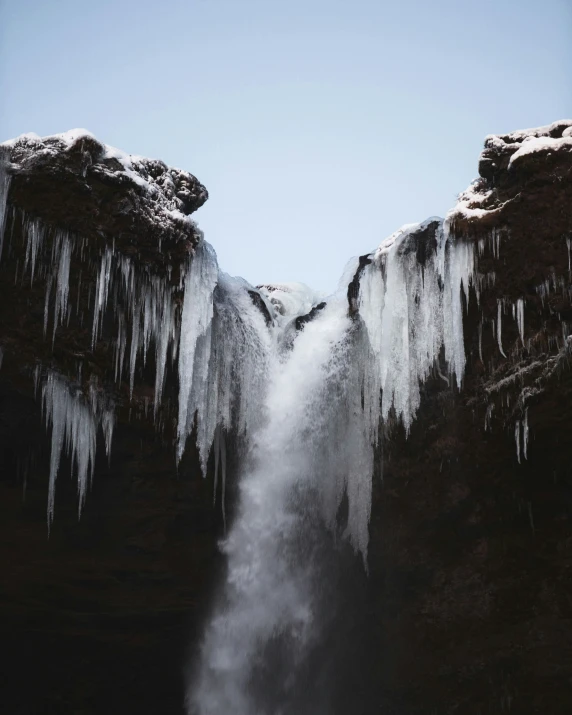 a waterfall with icicles hanging off of it