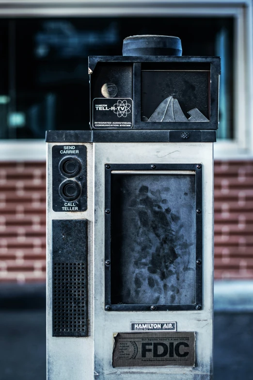 an old television on a stand outside next to a building