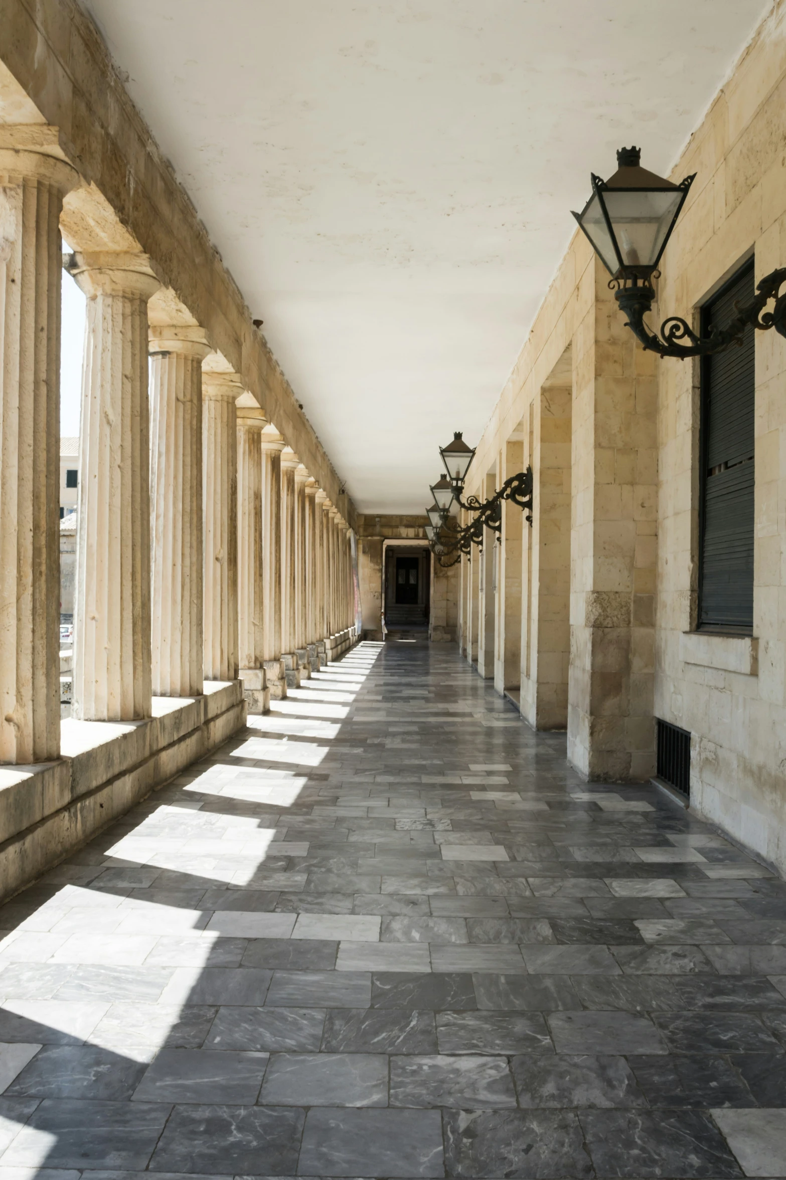 the walkway leading into a building with columns