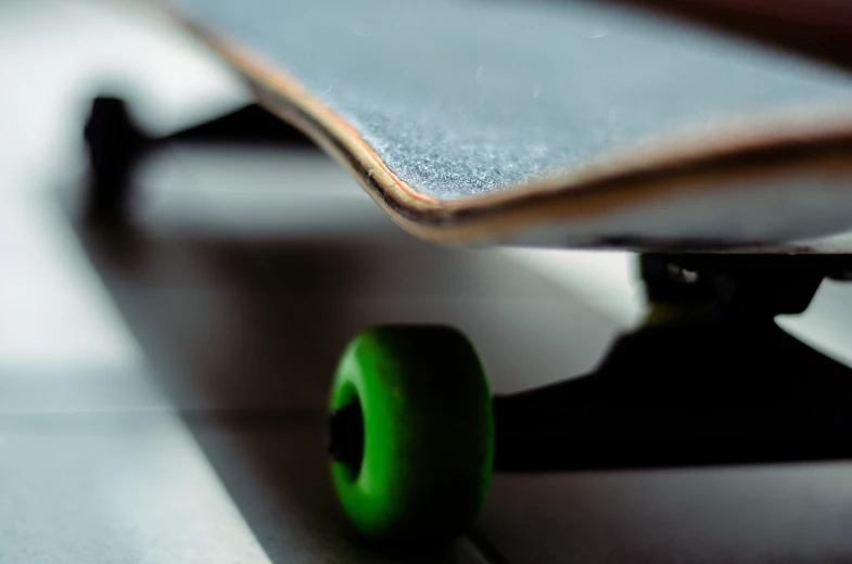 green wheel on a skateboard is visible